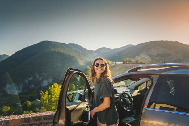 Young beautiful woman traveling by car in the mountains, summer vacation and adventure Young beautiful woman traveling by car in the mountains, summer vacatio.jpg